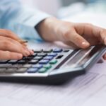 small business tax accountant professional calculating tax deductions before year-end